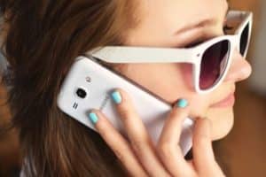 person sunglasses woman smartphone 300x200 1